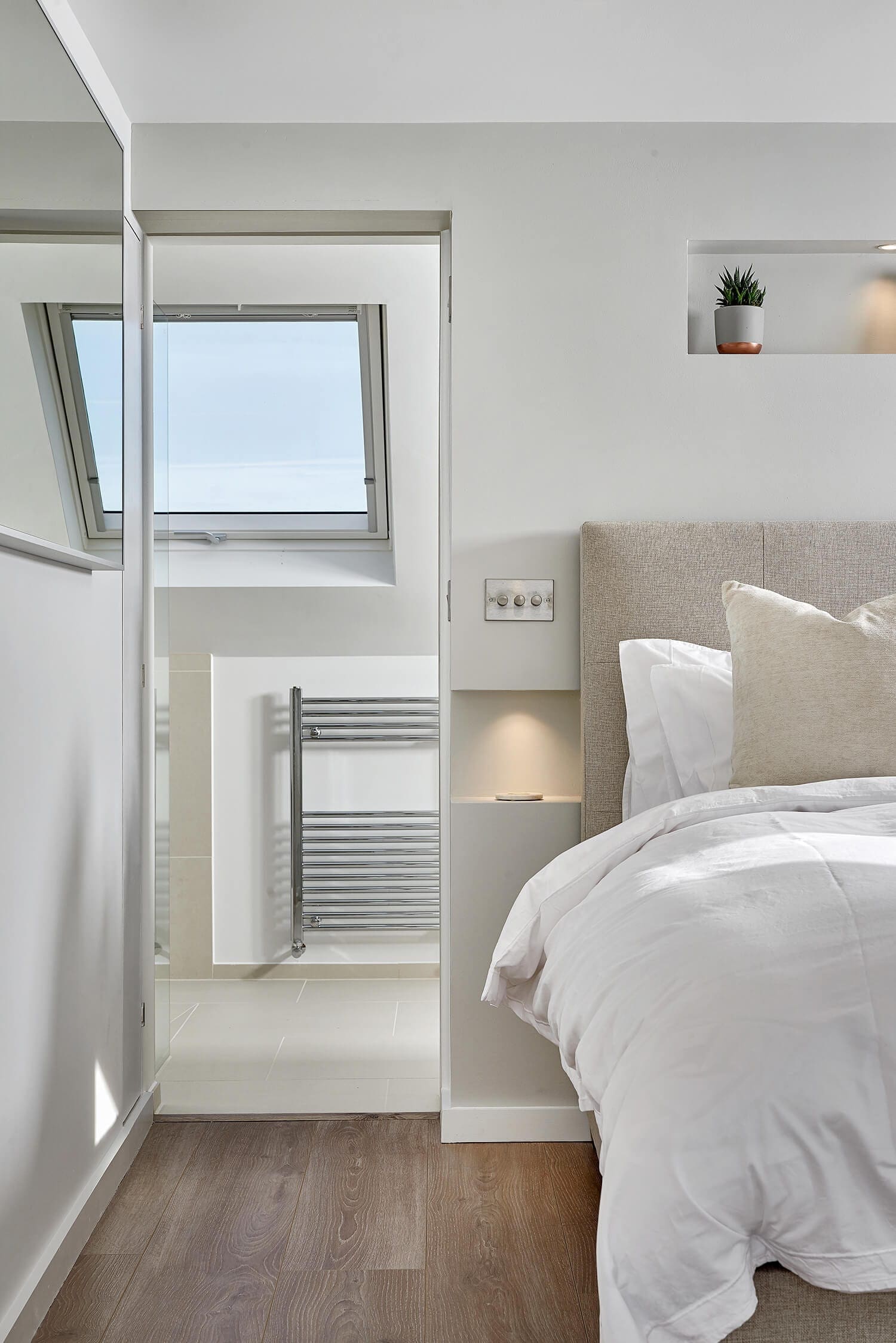 converted l-shaped loft bedroom with attached shower suite