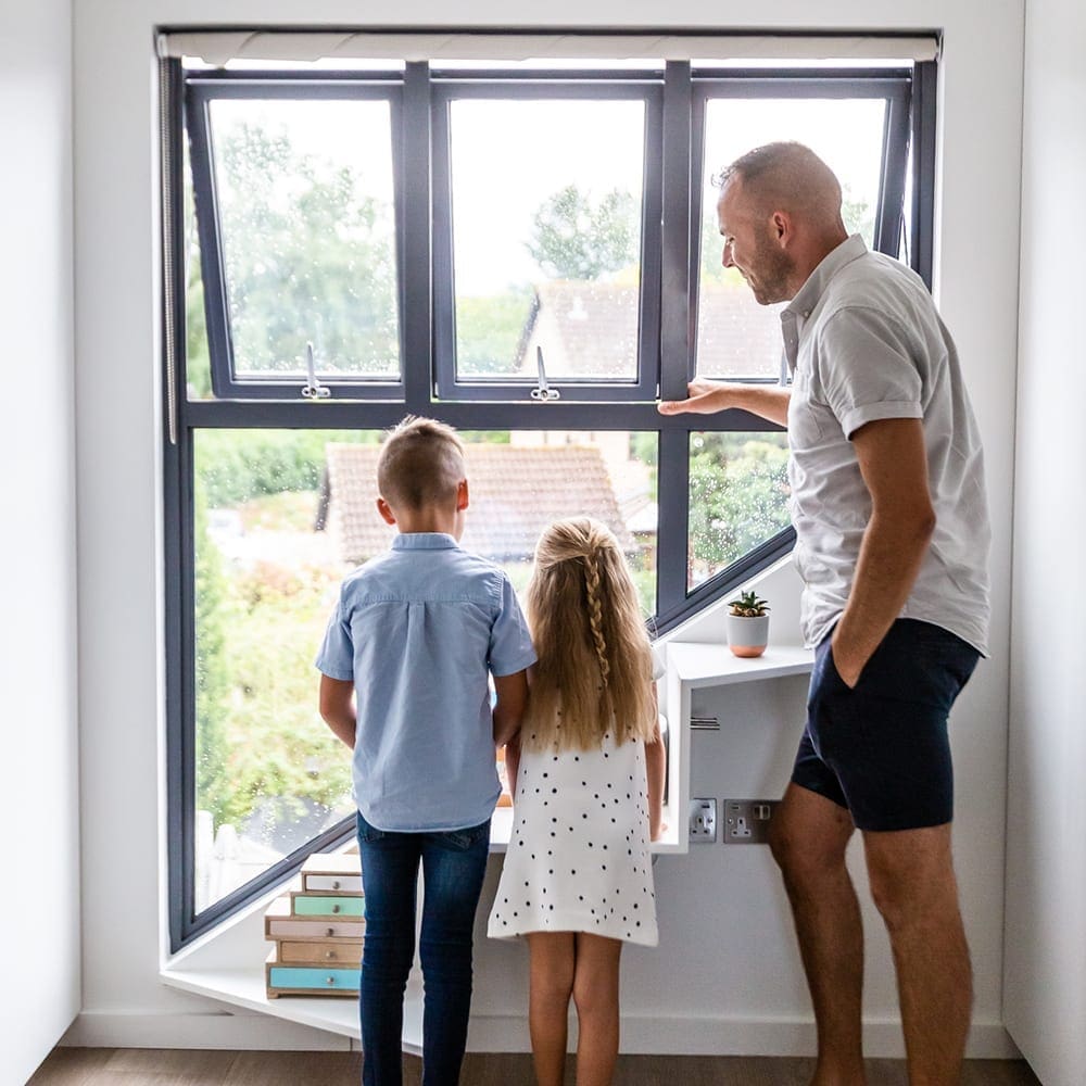 family standing by loft window for ventilation