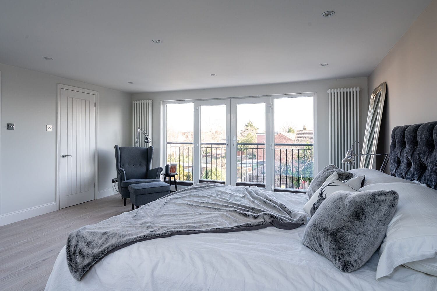master bedroom loft conversion with metal railed balcony 