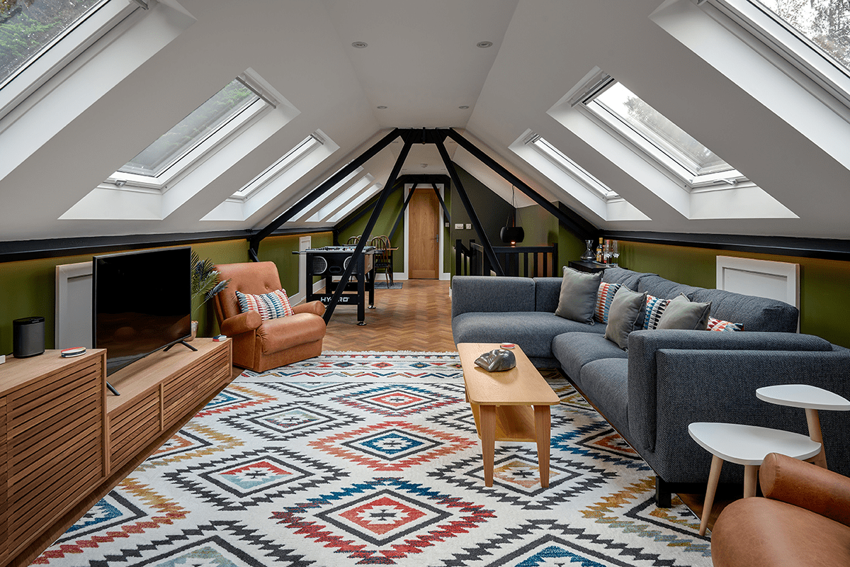 multi-use loft conversion playroom with lounge and games area in modern boho style