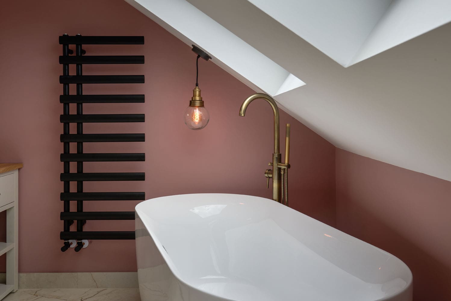 loft bath below two velux windows lets in natural daylight