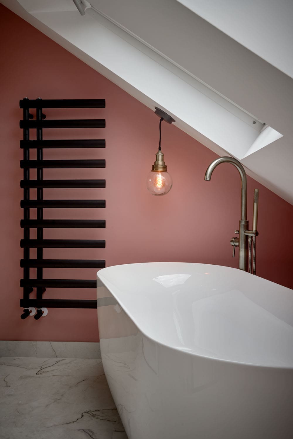 slopped loft bathroom ceiling above bath pendant light